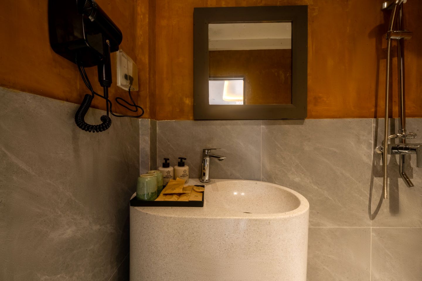Stone basin and bath amenities detail