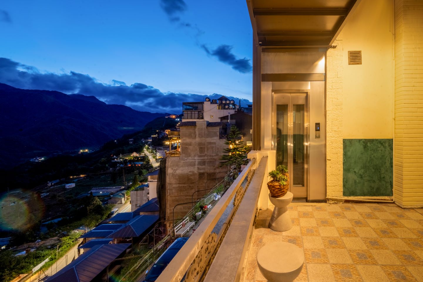 Balcony terrace at blue hour above the valley lights